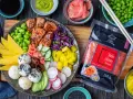 Kolorowy bowl z lososiem, ryżem, mango, edamame, awokado i marynowanym imbirem różowym.