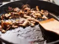 Pokrojone pieczarki smażą się na patelni, tworząc pyszny dodatek do wielu dań. Idealne, by dowiedzieć się, co zrobić z pieczarek.
