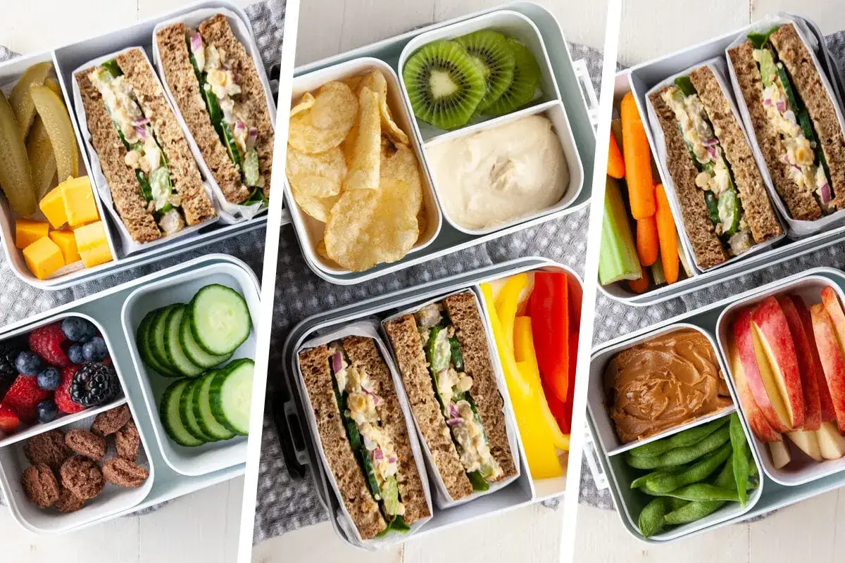 Kolorowe pudełka z jedzeniem na lunch do pracy: kanapki, owoce, warzywa, hummus i przekąski.